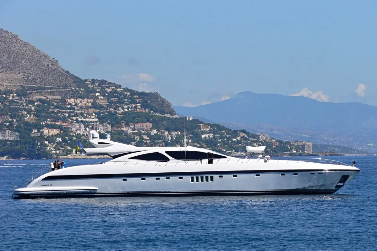 Mangusta 130, main deck — Mallorca Yachst Hire, Mallorca. Open-water speed toward Cap de Formentor at dusk