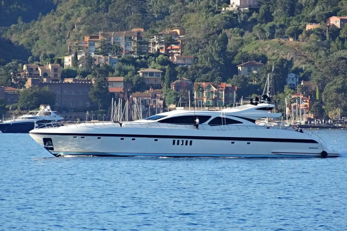 Mangusta 130, aft deck — Mallorca Yachst Hire, Mallorca. Open-water speed toward Cap de Formentor at dusk