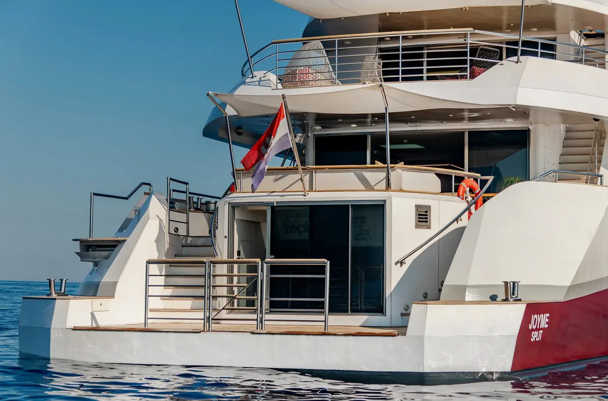 Philip Zepter 50m, aft deck — Mallorca Yachst Hire, Mallorca. Fifty metres of calm beneath Tramuntana's cliffs at sunset